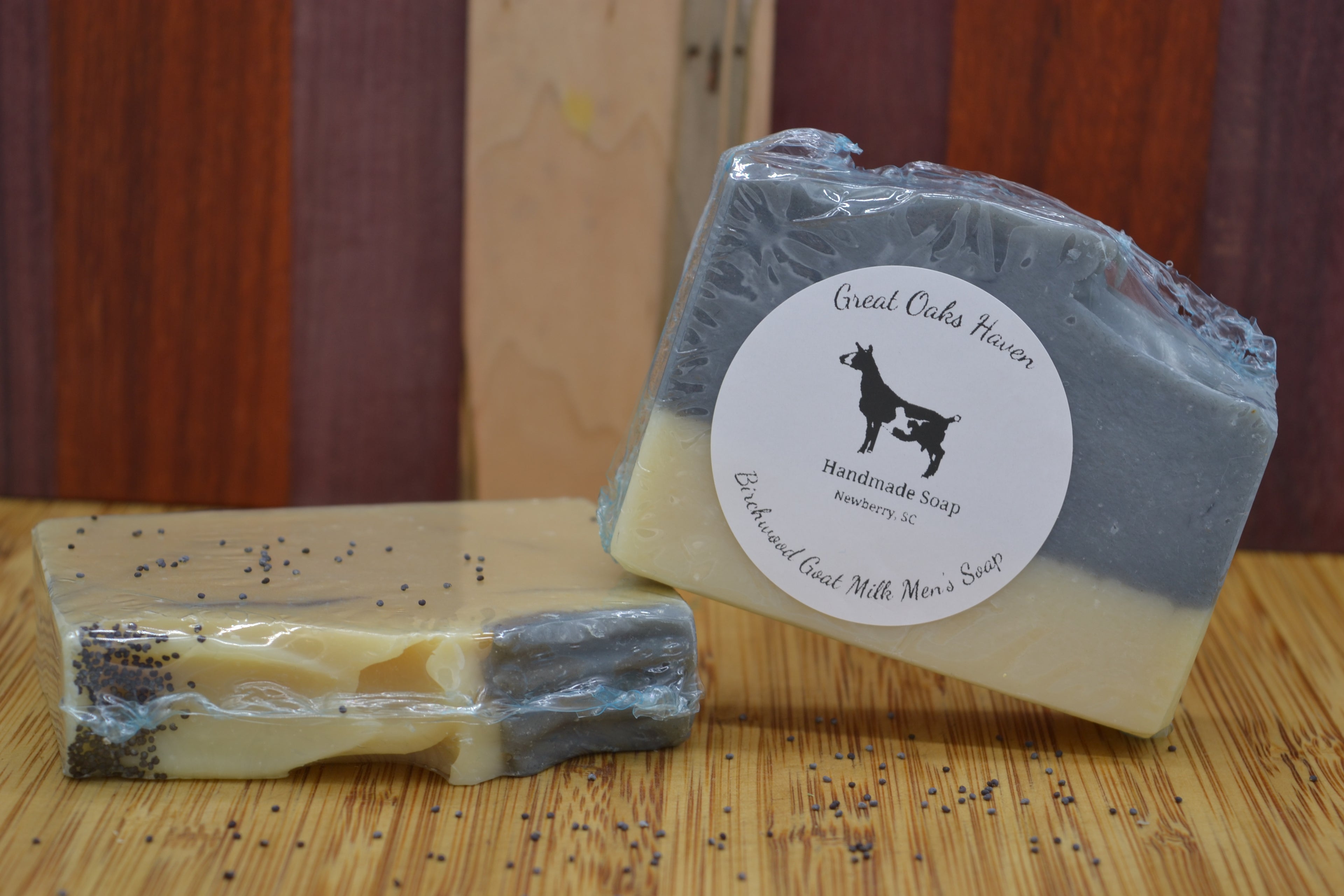 Two bars of soap with a label on a wooden surface